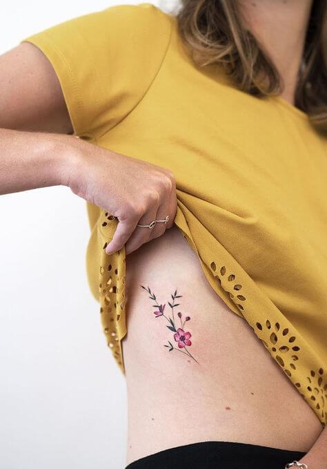 Tiny flower on the rib by xenaink  Tattoogridnet