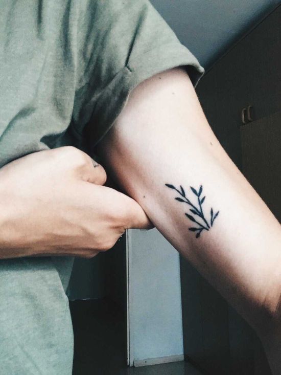 Tiny minimalistic leaf tattoo located on the inner arm.