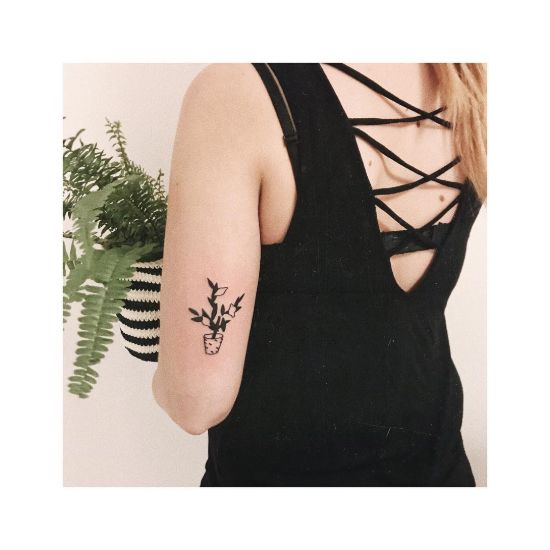 Minimalist flower pot tattoo on girls forearm