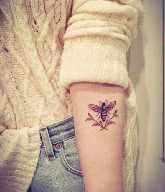 Honey bee tattoo on the girl's forearm