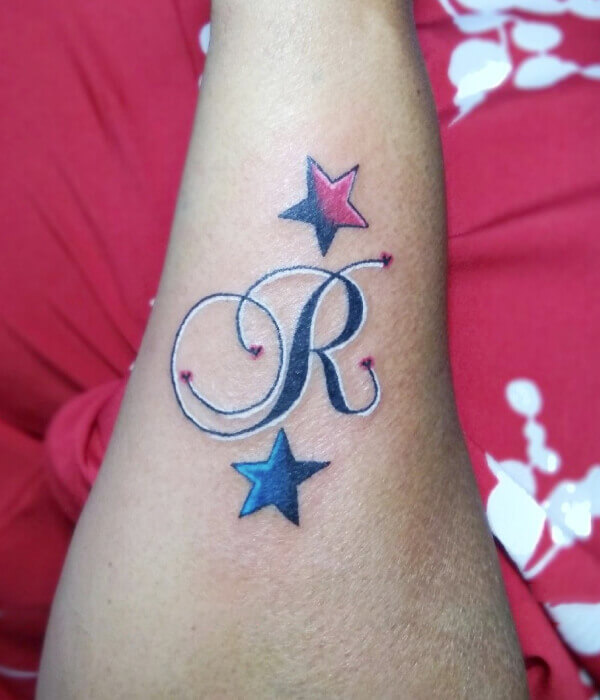 Letter R tattoo on the wrist