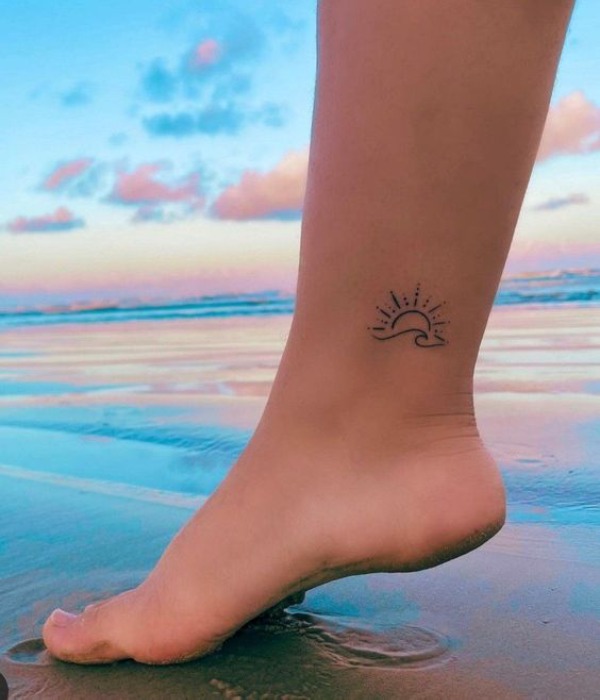 Tiny sun ankle tattoo